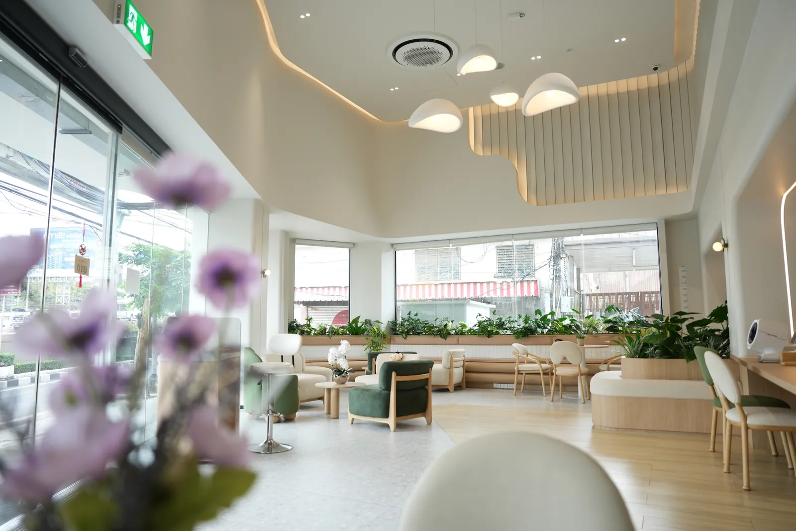 A waiting area by the window, with plants and flowers